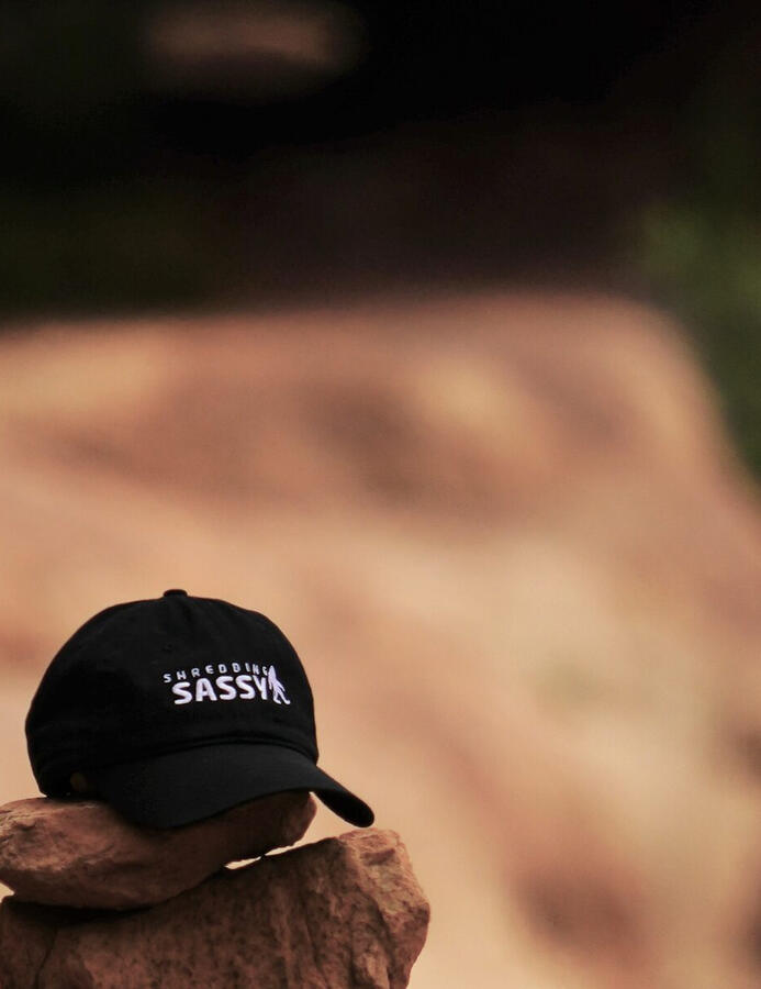 Untitled Black Shredding Sassy baseball cap on red desert rocks